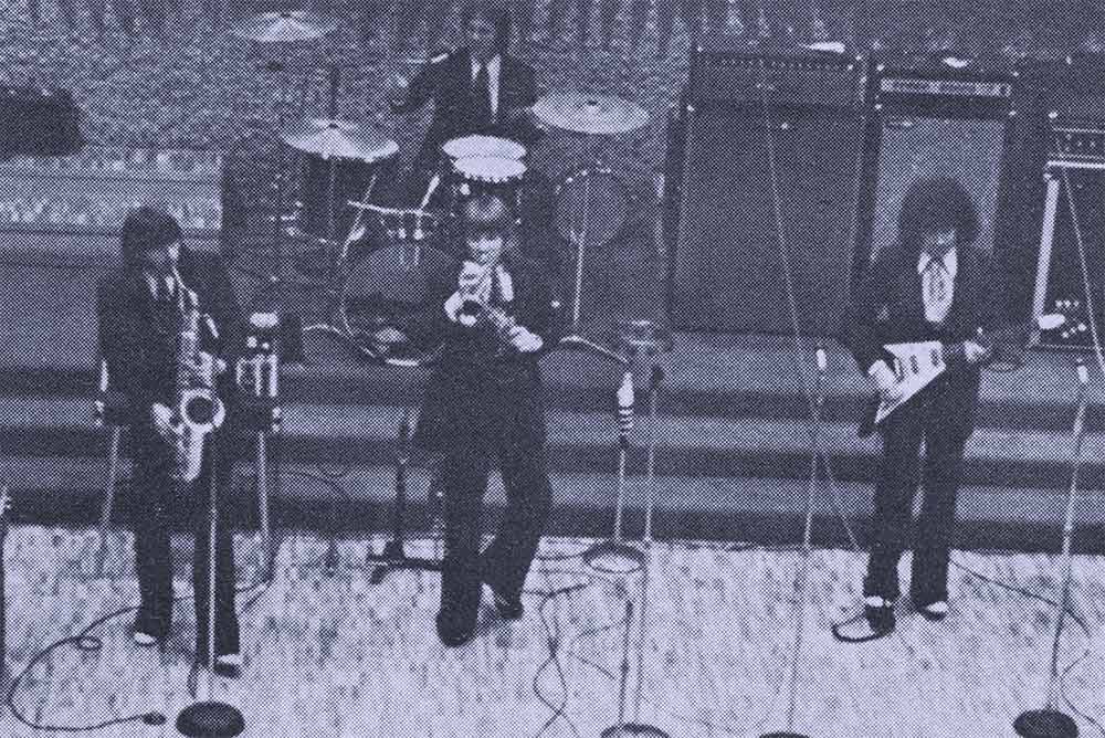 A treated photo of a band playing in the forum from the Journal 2009 acrhives.